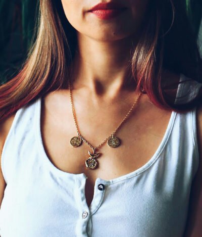 Woman wearing gold solar necklace jewelry