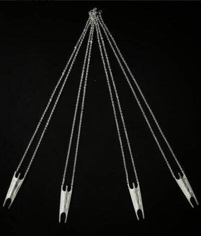 Set of silver Igorot shield necklaces on black background – tribal amulets reflecting strength and unity.